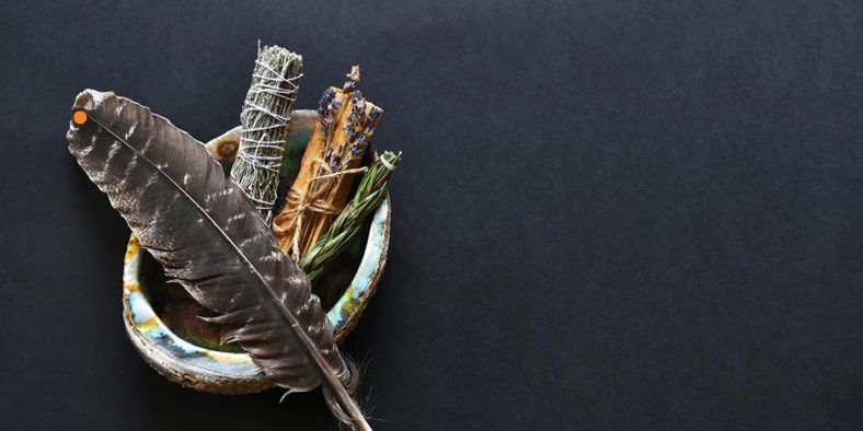 A smudging kit with white sage and palo santo.
