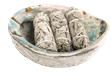 A bundle of white sage producing smoke.